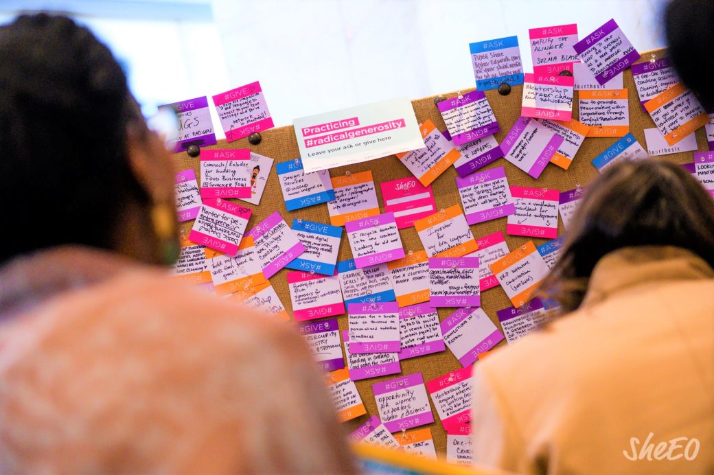Women at SheEO mini-summit Auckland - looking at post it notes.